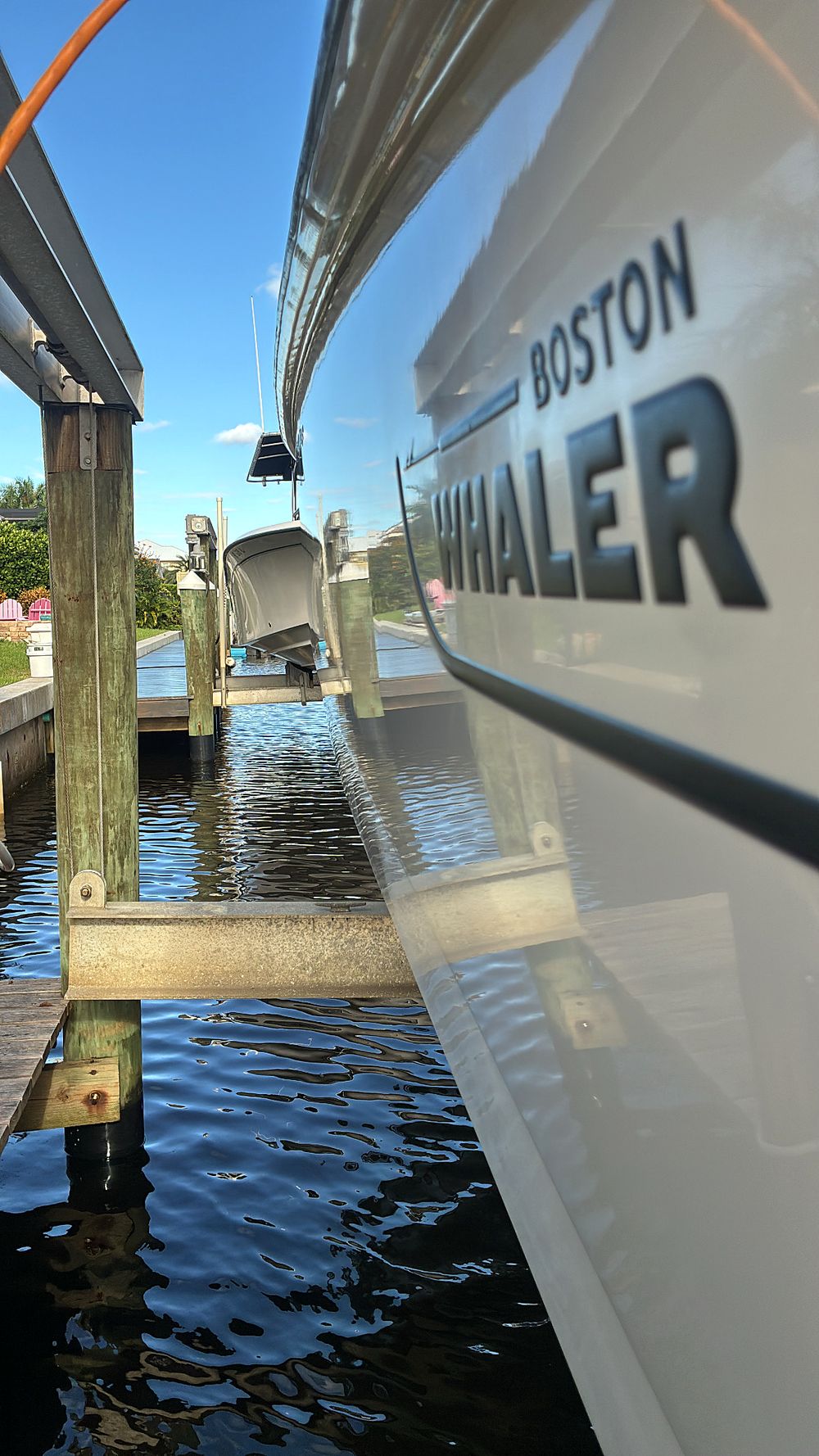 Boston Whaler hull reflecting the dock like a mirror