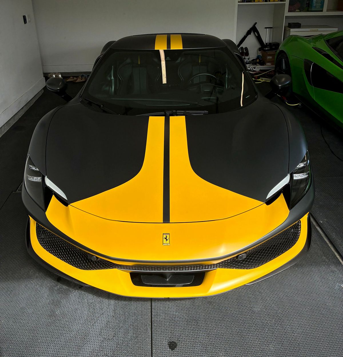 Yellow and black Ferrari 296 GTB in the garage after detailing